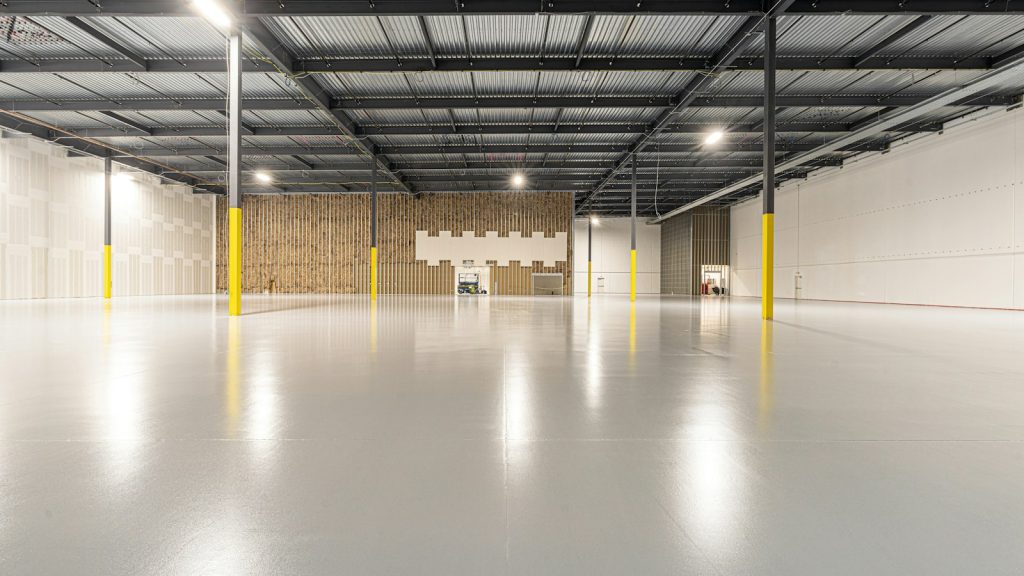 Empty warehouse with a clean concrete floor, ready for handover