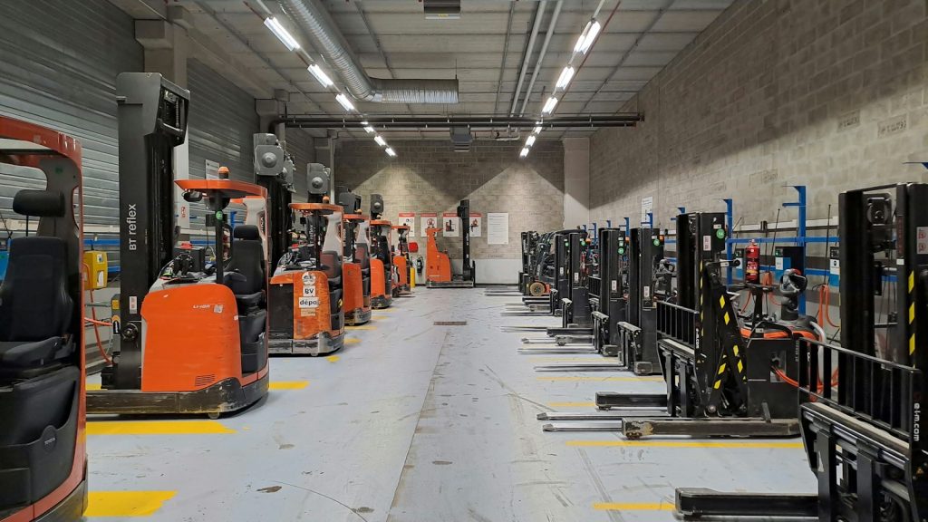 Industrial warehouse with forklifts and storage