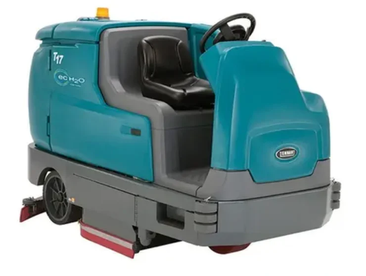 Ride-on auto-scrubber cleaning a large warehouse floor